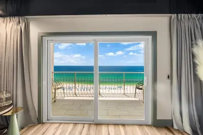 a door to a balcony with a view of the ocean at The Summit 1107 in Panama City Beach