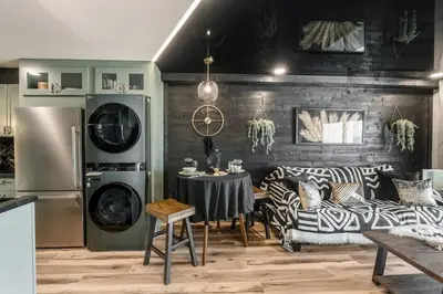 a living room with a table and a refrigerator at The Summit 1107 in Panama City Beach