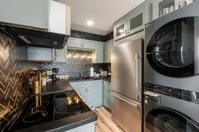 a kitchen with a stove and a washer and dryer at The Summit 1107 in Panama City Beach