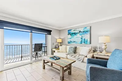 a living room with a couch and a table at The Summit 1121 in Panama City Beach