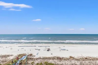 a beach with a lot of people on it and the ocean at The Summit 1011 in Panama City Beach