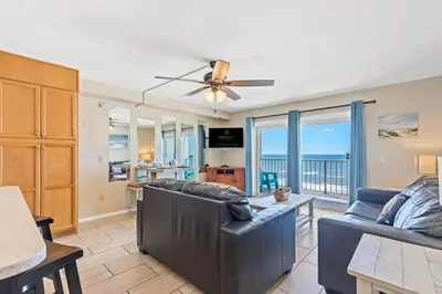 a living room with a couch and a ceiling fan at The Summit 1011 in Panama City Beach