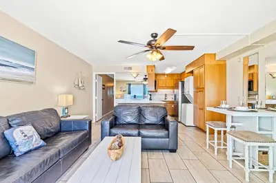 a living room with a couch and a kitchen at The Summit 1011 in Panama City Beach
