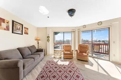a living room with a couch and two chairs at 1302B St Thomas Square in Panama City Beach