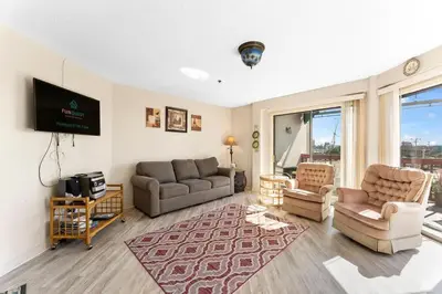 a living room with a couch and a tv at 1302B St Thomas Square in Panama City Beach