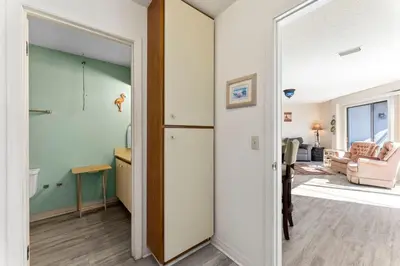 a hallway with a door leading to a living room at 1302B St Thomas Square in Panama City Beach