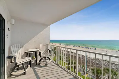 a balcony with two chairs and a view of the beach at The Summit 602 in Panama City Beach