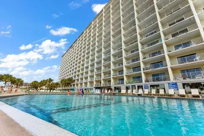 a swimming pool in front of a large building at The Summit 602 in Panama City Beach