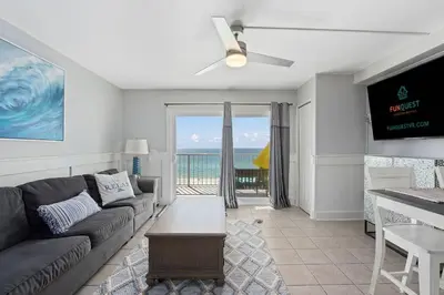 a living room with a couch and a view of the ocean at The Summit 624 in Panama City Beach