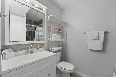 a white bathroom with a sink and a toilet at The Summit 624 in Panama City Beach