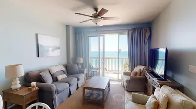 a living room with a couch and a tv at Brightly Furnished Beachfront Condo by Brightwild- 7th Floor Gulf View! in Panama City Beach