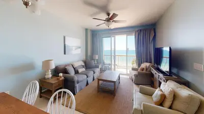 a living room with a couch and a tv at Brightly Furnished Beachfront Condo by Brightwild- 7th Floor Gulf View! in Panama City Beach