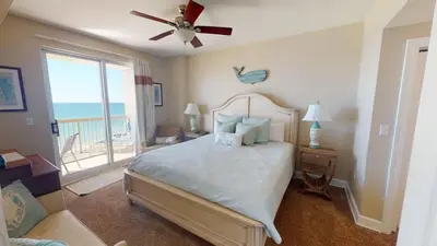 a bedroom with a bed with a ceiling fan at 8th Floor Gulf View Beachfront Condominium by Brightwild in Panama City Beach