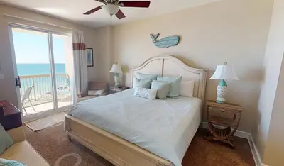 a bedroom with a bed with a view of the ocean at 8th Floor Gulf View Beachfront Condominium by Brightwild in Panama City Beach
