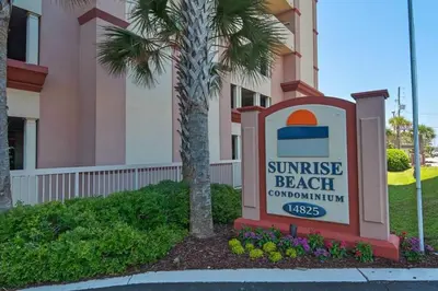 a sign in front of a building with a sunrise beach subdivision at 8th Floor Gulf View Beachfront Condominium by Brightwild in Panama City Beach
