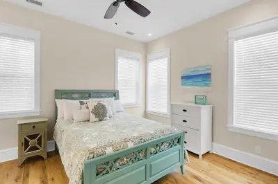 a bedroom with a bed and a ceiling fan at Calm Breeze Cottage in Santa Rosa Beach