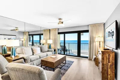 a living room with a couch and a table at Commodore 903 (2/2) in Panama City Beach