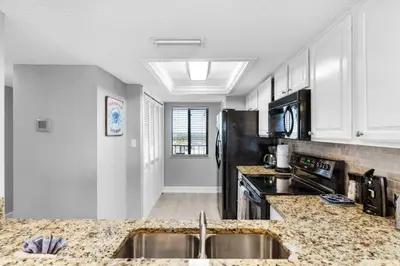 a kitchen with a sink and a counter top at Commodore 903 (2/2) in Panama City Beach