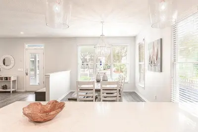 a kitchen and dining room with a table and chairs at Cassine Dream in Santa Rosa Beach