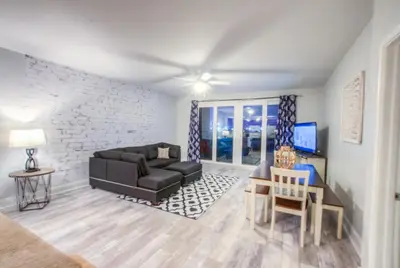 a living room with a couch and a table at BRAND NEW!Laketown Wharf 334! Beautiful 3 BD, Great Amenities, And Great Location in Panama City Beach