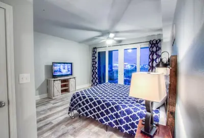 a bedroom with a bed and a television at BRAND NEW!Laketown Wharf 334! Beautiful 3 BD, Great Amenities, And Great Location in Panama City Beach