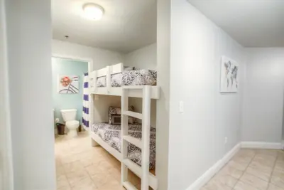 a room with two bunk beds and a bathroom at BRAND NEW!Laketown Wharf 334! Beautiful 3 BD, Great Amenities, And Great Location in Panama City Beach