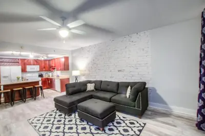 a living room with a couch and a kitchen at BRAND NEW!Laketown Wharf 233! Beautiful 3 BD, Great Amenities, And Great Location in Panama City Beach