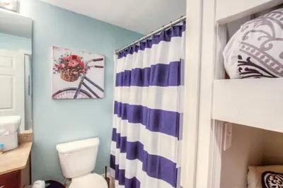 a bathroom with a toilet and a shower curtain at BRAND NEW!Laketown Wharf 233! Beautiful 3 BD, Great Amenities, And Great Location in Panama City Beach
