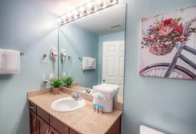 a bathroom with a sink and a mirror at BRAND NEW!Laketown Wharf 233! Beautiful 3 BD, Great Amenities, And Great Location in Panama City Beach