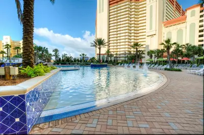 a swimming pool at a resort with palm trees and buildings at BRAND NEW!Laketown Wharf 233! Beautiful 3 BD, Great Amenities, And Great Location in Panama City Beach