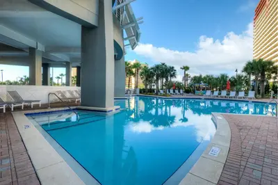 a swimming pool at a hotel with blue water at BRAND NEW!Laketown Wharf 233! Beautiful 3 BD, Great Amenities, And Great Location in Panama City Beach
