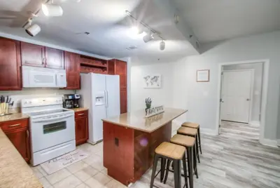 a kitchen with white appliances and wooden cabinets at BRAND NEW!Laketown Wharf 233! Beautiful 3 BD, Great Amenities, And Great Location in Panama City Beach