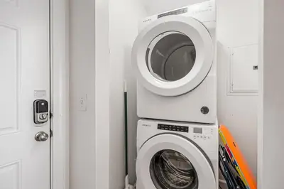 a washing machine and a washer in a room at Fantastic Private Complex -Beachfront 2BD Ocean Villa! Gorgeous Amenities in Panama City Beach