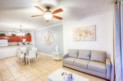 a living room with a couch and a table at Fantastic Private Complex -Beachfront 2BD Ocean Villa! Gorgeous Amenities in Panama City Beach