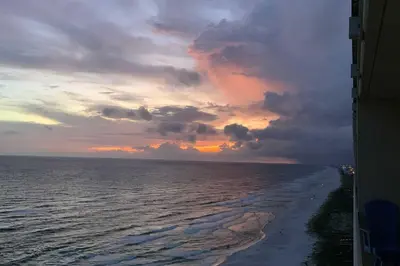 a view of the ocean with a sunset at Waterfront PCB Condo with Balcony and Beach Gear! in Panama City Beach