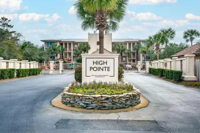 a sign in the middle of a road with a palm tree at High Pointe Resort 414 in Rosemary Beach