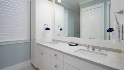 a bathroom with two sinks and a large mirror at That Summer Feeling in Inlet Beach