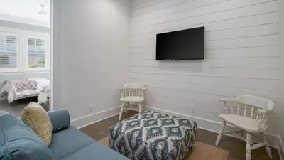 a living room with a couch and a tv on the wall at That Summer Feeling in Inlet Beach