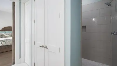 a bathroom with a walk in shower next to a bedroom at That Summer Feeling in Inlet Beach