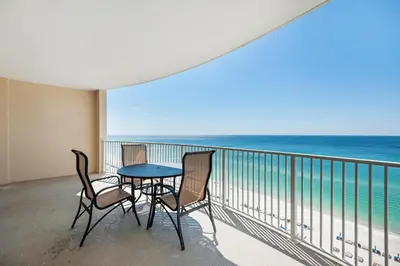 a balcony with a table and chairs and the ocean at Ocean Villa 1102 in Panama City Beach