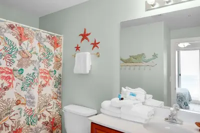 a bathroom with a sink and a mirror at Ocean Villa 1102 in Panama City Beach