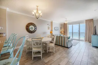 a dining room and living room with a table and chairs at Ocean Villa 1102 in Panama City Beach