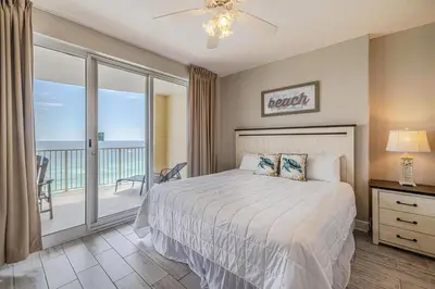 a bedroom with a bed and a balcony at Ocean Villa 1102 in Panama City Beach