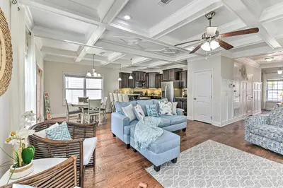 a living room with a blue couch and a dining room at Half Mi to Inlet Beach Home with Grill and Fire Pit in Inlet Beach