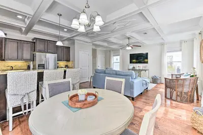 a kitchen and living room with a table and a couch at Half Mi to Inlet Beach Home with Grill and Fire Pit in Inlet Beach