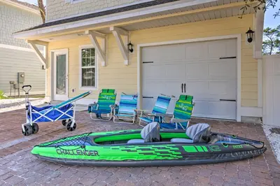 a green inflatable kayak in front of a house at Half Mi to Inlet Beach Home with Grill and Fire Pit in Inlet Beach