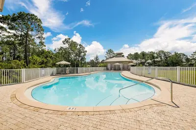 a swimming pool in a yard with a fence at Seagrove Highlands by Panhandle Getaways in Santa Rosa Beach