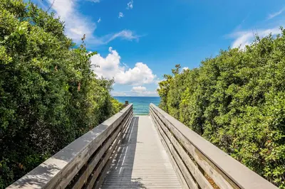 a boardwalk leading to the ocean on the beach at Seagrove Highlands by Panhandle Getaways in Santa Rosa Beach