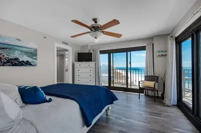 a bedroom with a bed and a ceiling fan at Commodore 801 (3/3) in Panama City Beach