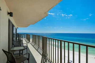 a balcony with chairs and a view of the ocean at Commodore 801 (3/3) in Panama City Beach